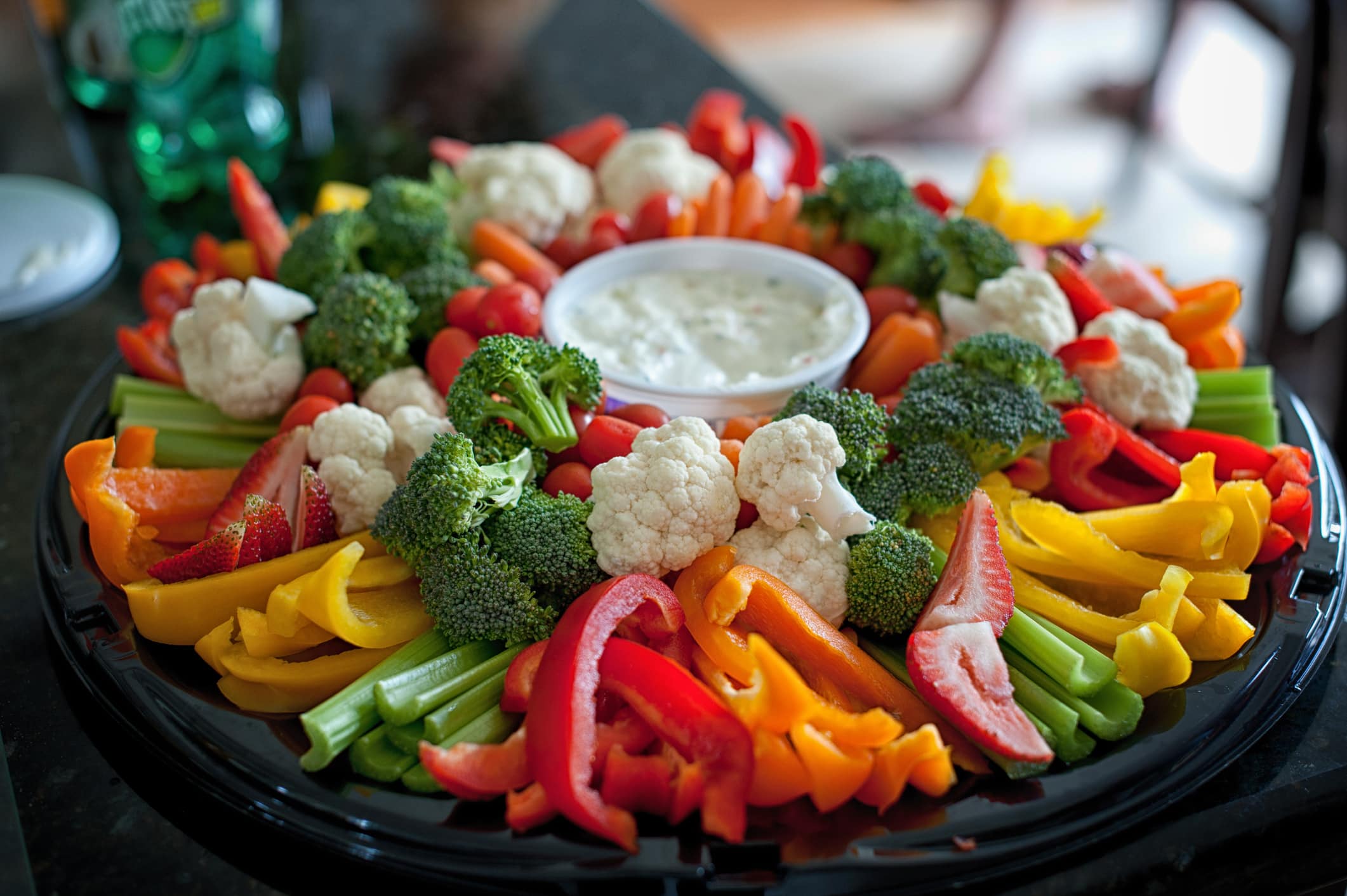 A fresh tray of colourful vegetables with dip.