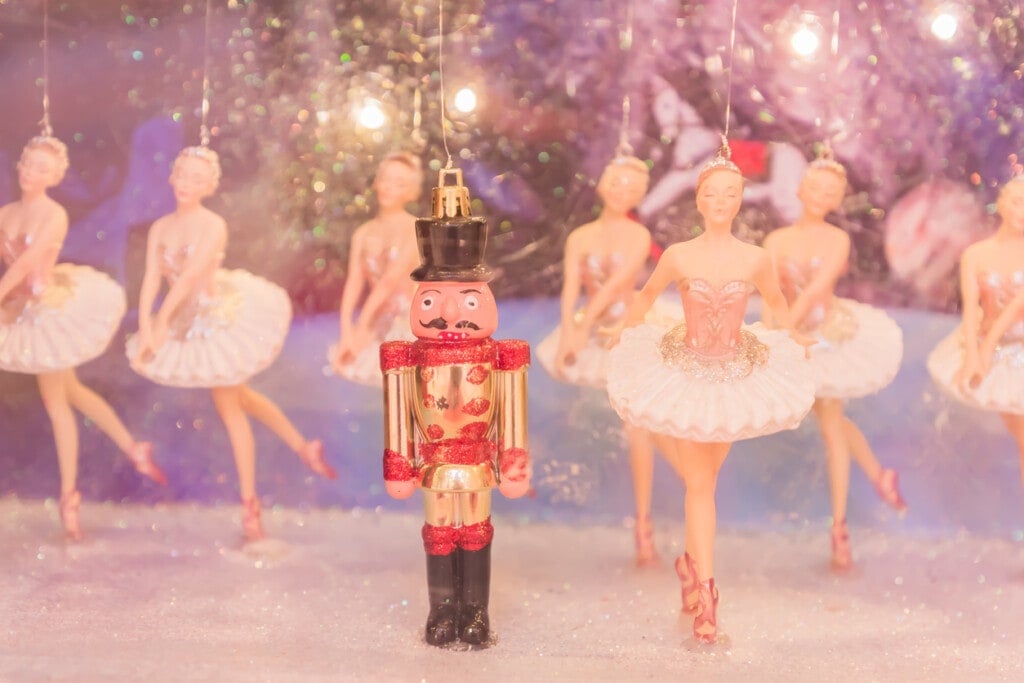 Christmas nutcracker toy soldier and ballerina dolls on the stage.