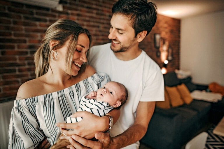 Happy family with newborn in hands