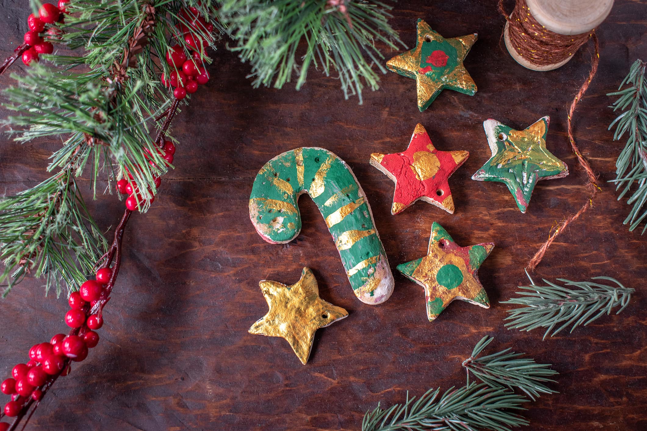 hand painted Christmas salt dough ornaments on festive wood table