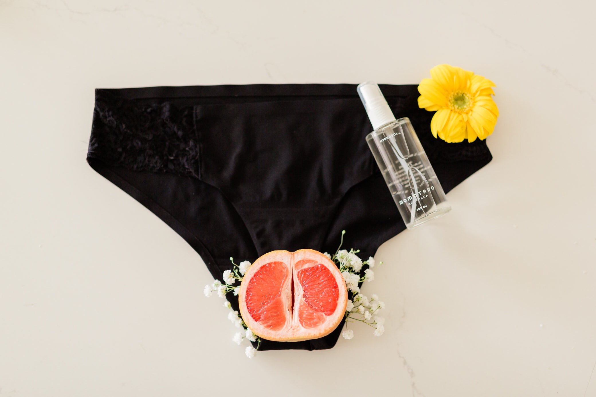 Black postpartum underwear with momotaro spray.