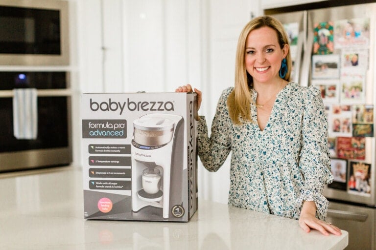 Nina, The Baby Chick, standing next to the baby brezza formula pro in her kitchen.