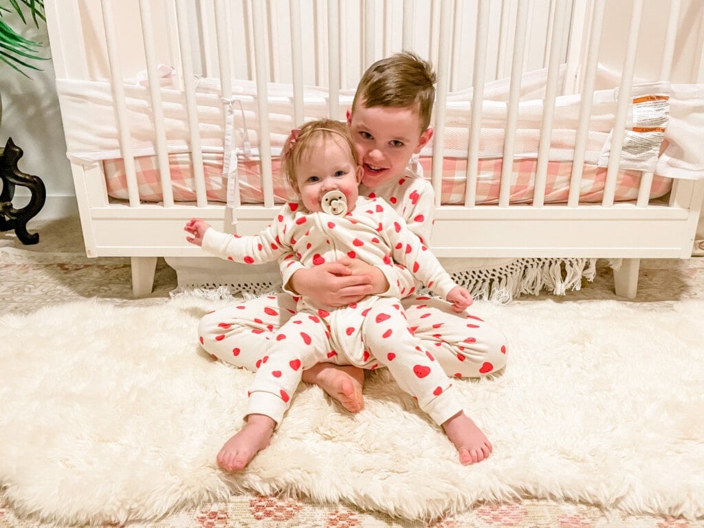 Toddler boy and baby girl wearing their Valentine pajamas