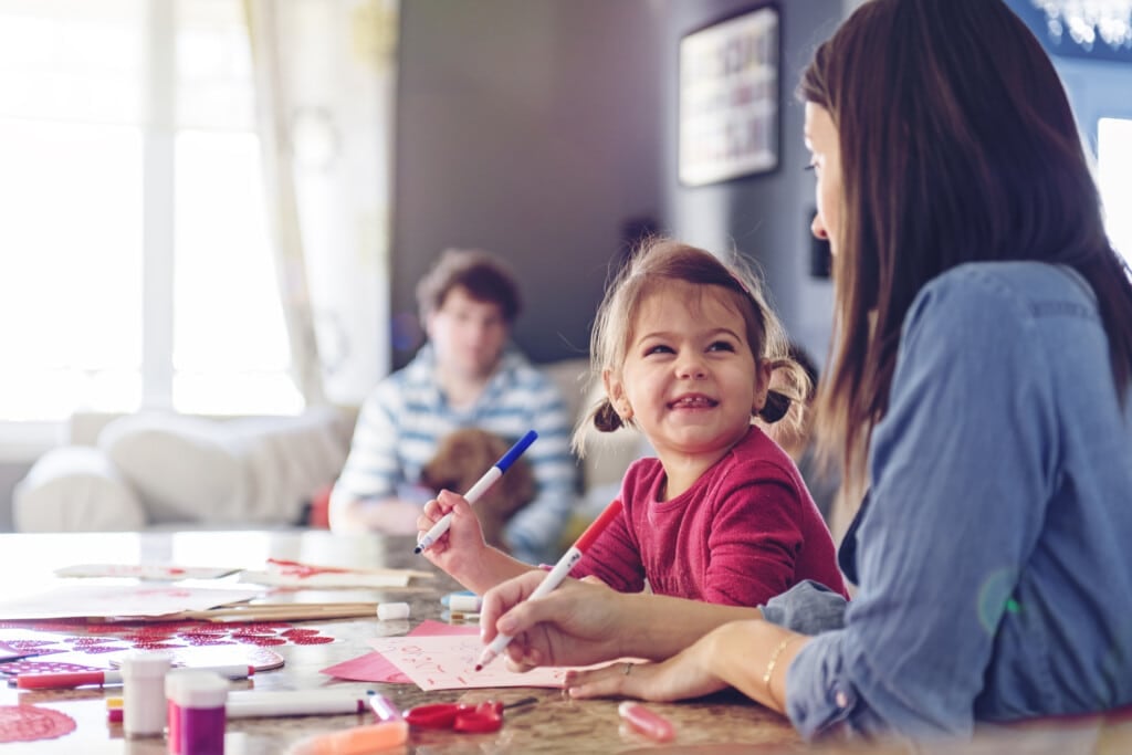 Mother making valentine cards with daughter