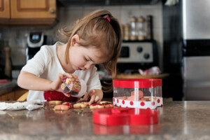 Little girl making valentine’s cookie