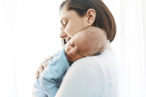 Mother with newborn son cuddling