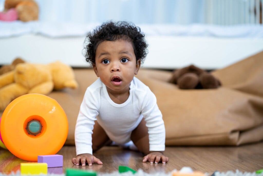 Happy African American Little baby boy crawling and looking for some thing to learn