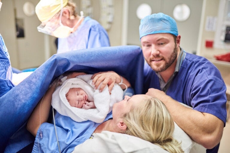 Shot of a beautiful young couple welcoming their newly born baby girl in the hospital