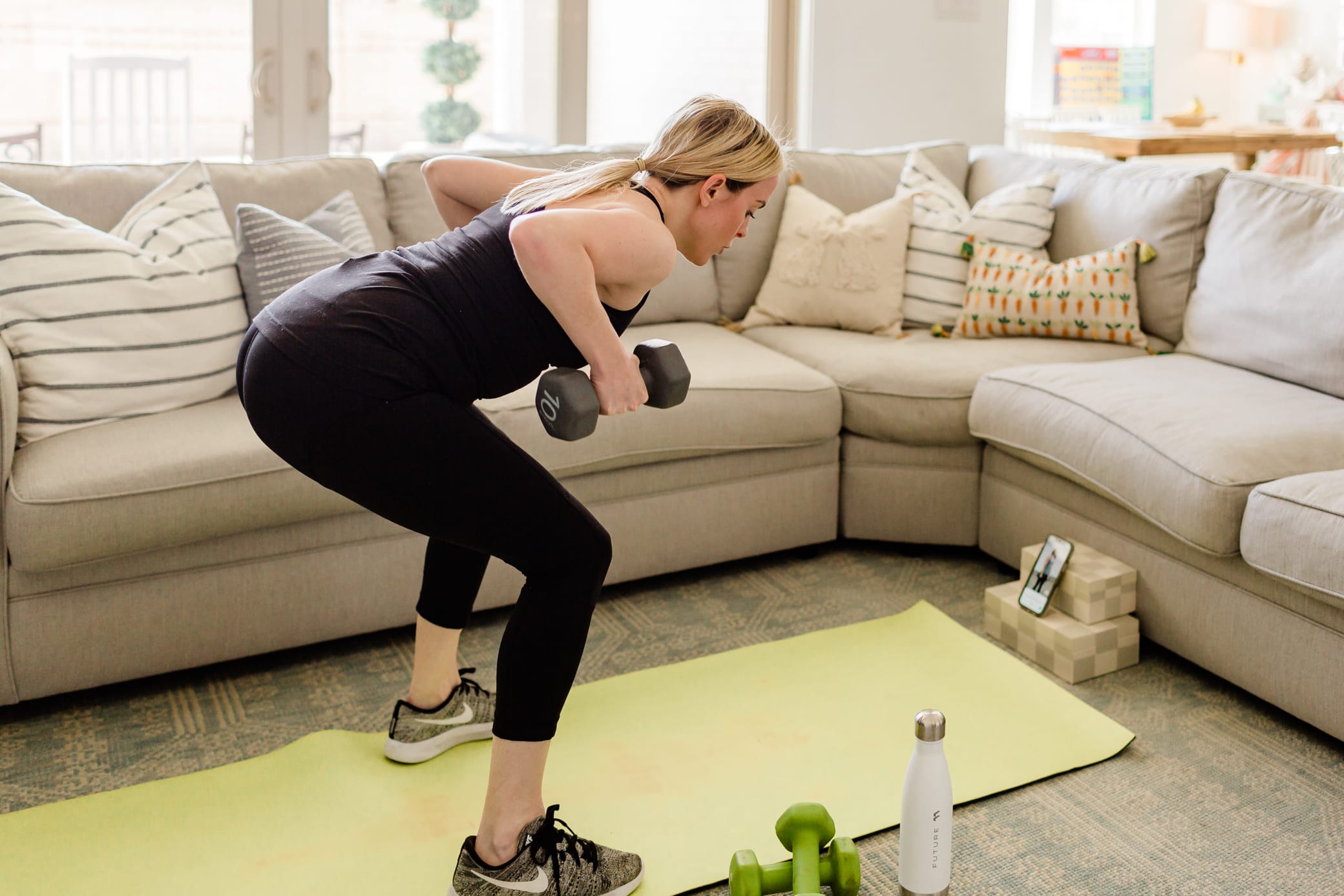 Mom doing an at home workout using the Future app.