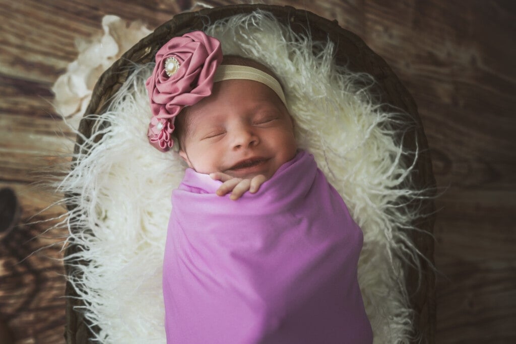 Smiling baby girl taking her newborn photos.