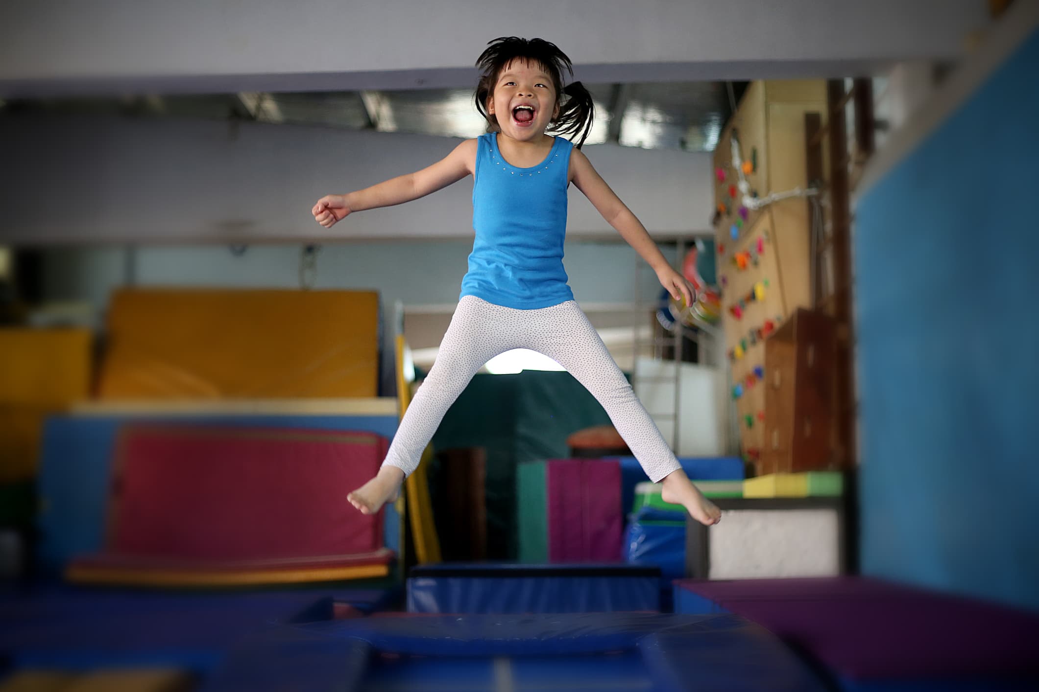 A young girl is enjoying herself with trampoline jump.