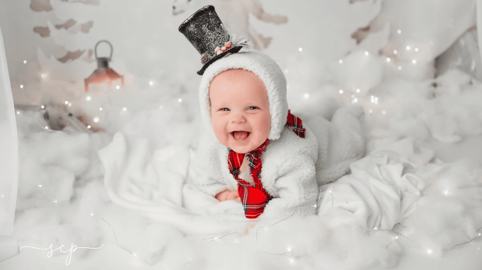 baby dressed in snowman outfit