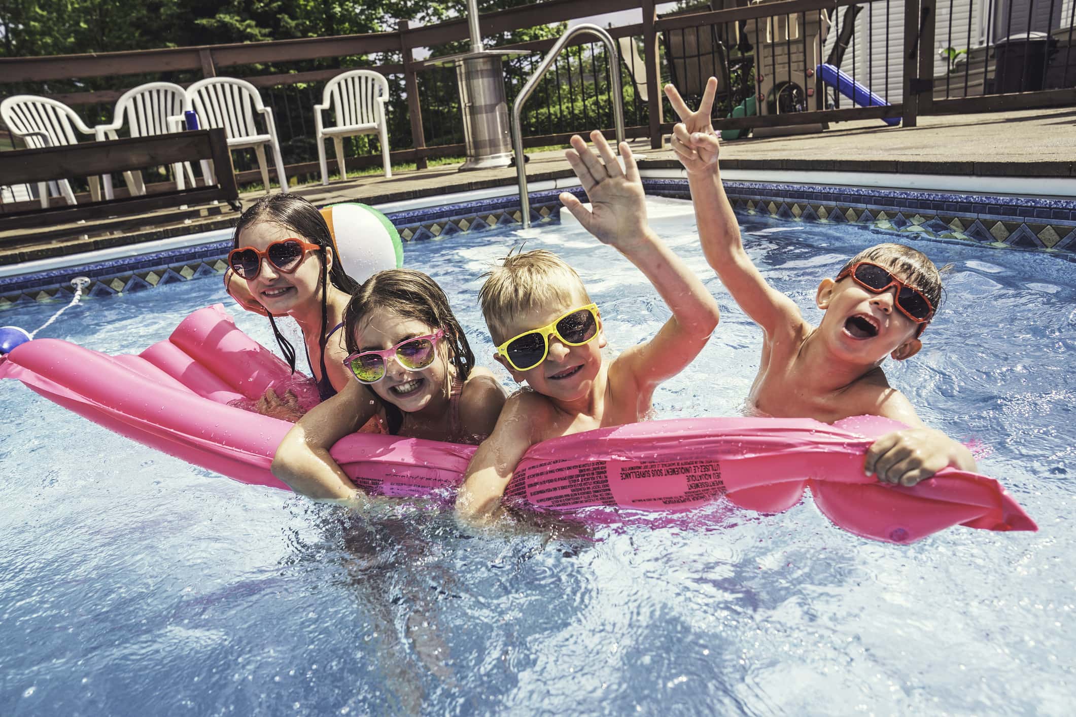 A group of children having fun in pool on the summer time