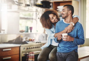 Shot of a happy young couple relaxing in the kitchen at home.