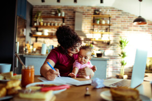 Close up of a mother having breakfast and doing bills with her daughter