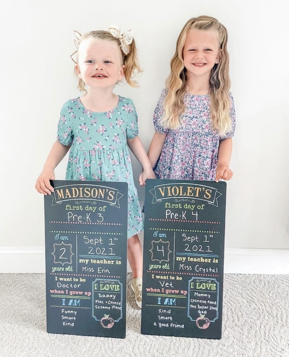 Two little girls holding their chalkboard back to school signs