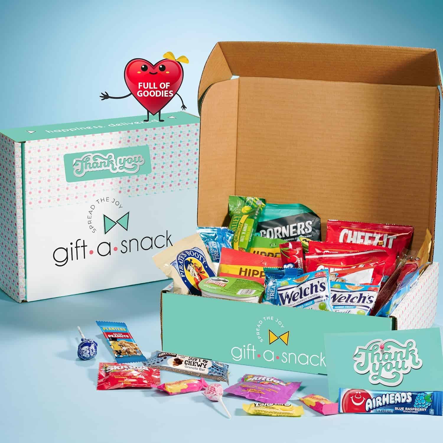 An open cardboard box labeled gift a snack brims with treats like chips, candies, and granola bars—perfect gifts for labor delivery nurses. Beside it is another closed box with Thank You printed on it. A cartoon heart with Full of Goodies floats above, ready to spread joy.