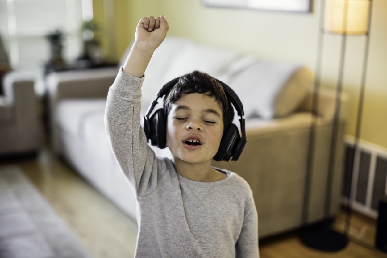 A child listening to music on wireless headphones