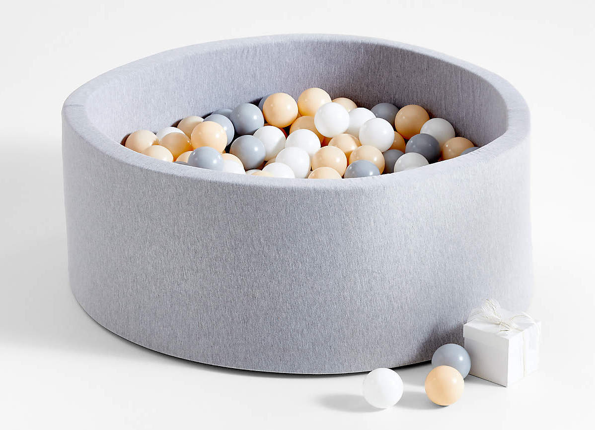 Grey ball pit with beige, white, and grey plastic balls inside 