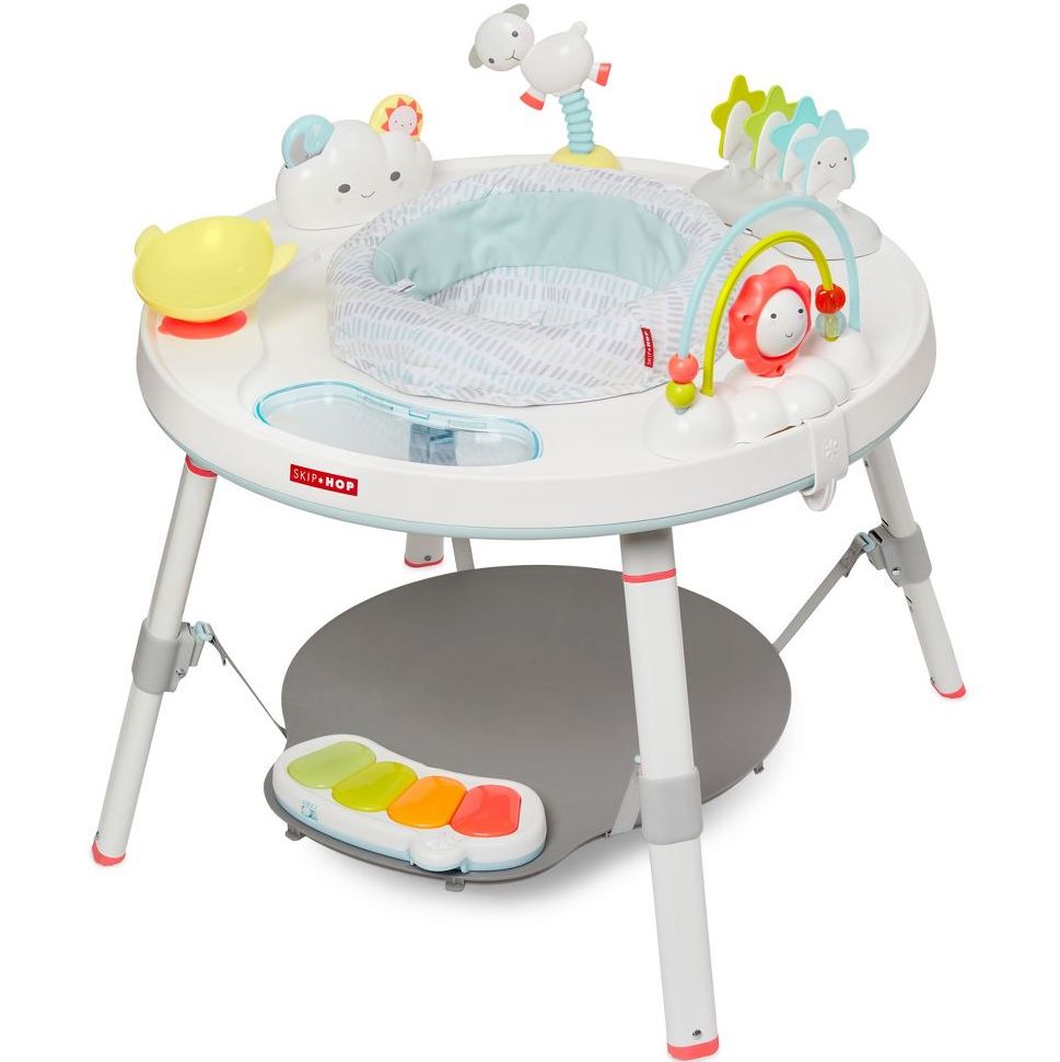 White activity center with different color toys and activities on it for babies to play with. 