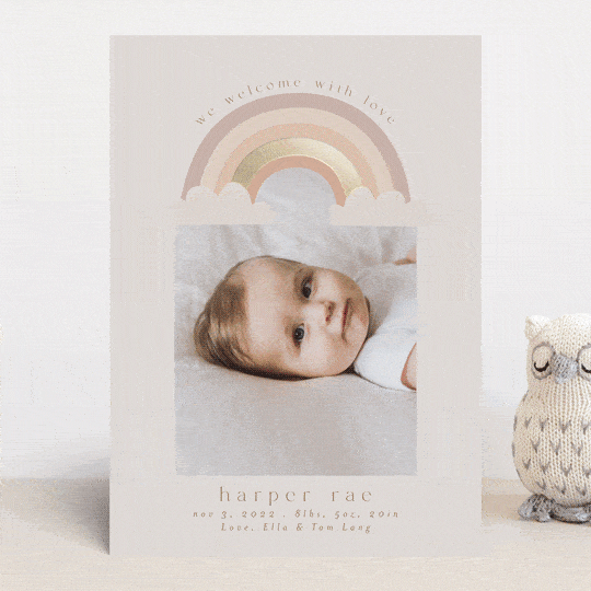 Card with picture of baby and a rainbow with birth announcement.