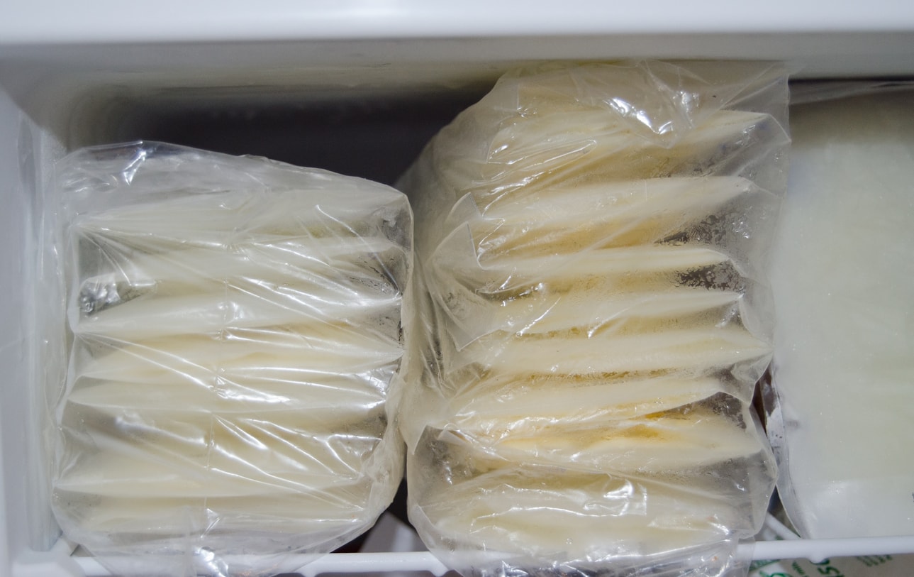 expresed breast milk packed in storage bags and frozen in the freezer, breastfeeding concept