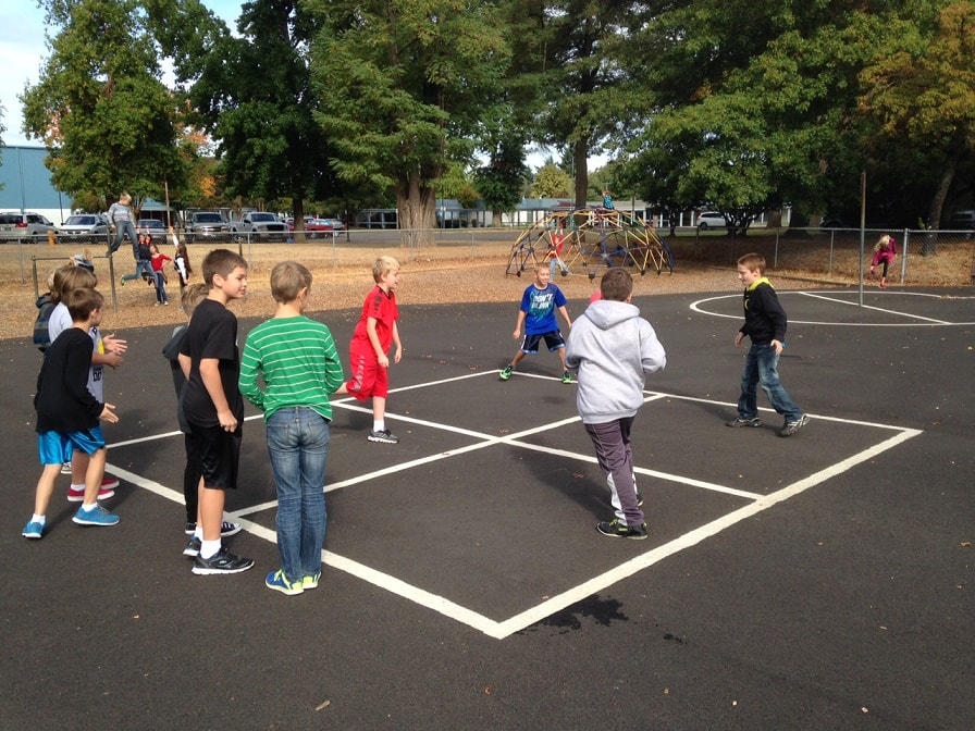 kids playing four square