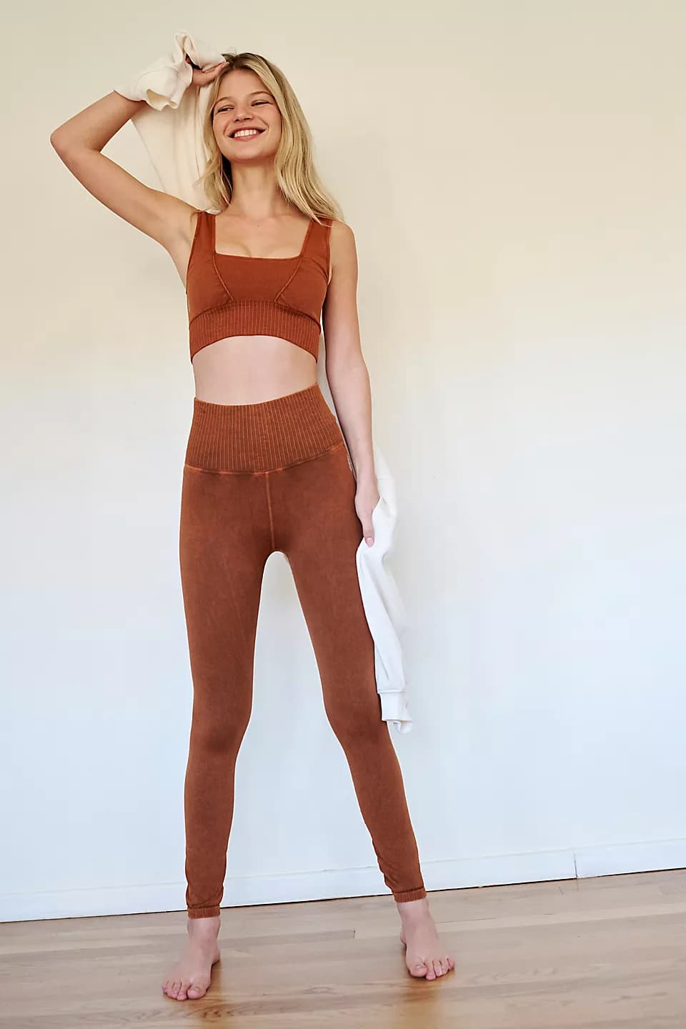 Woman in burnt orange leggings with matching top 
