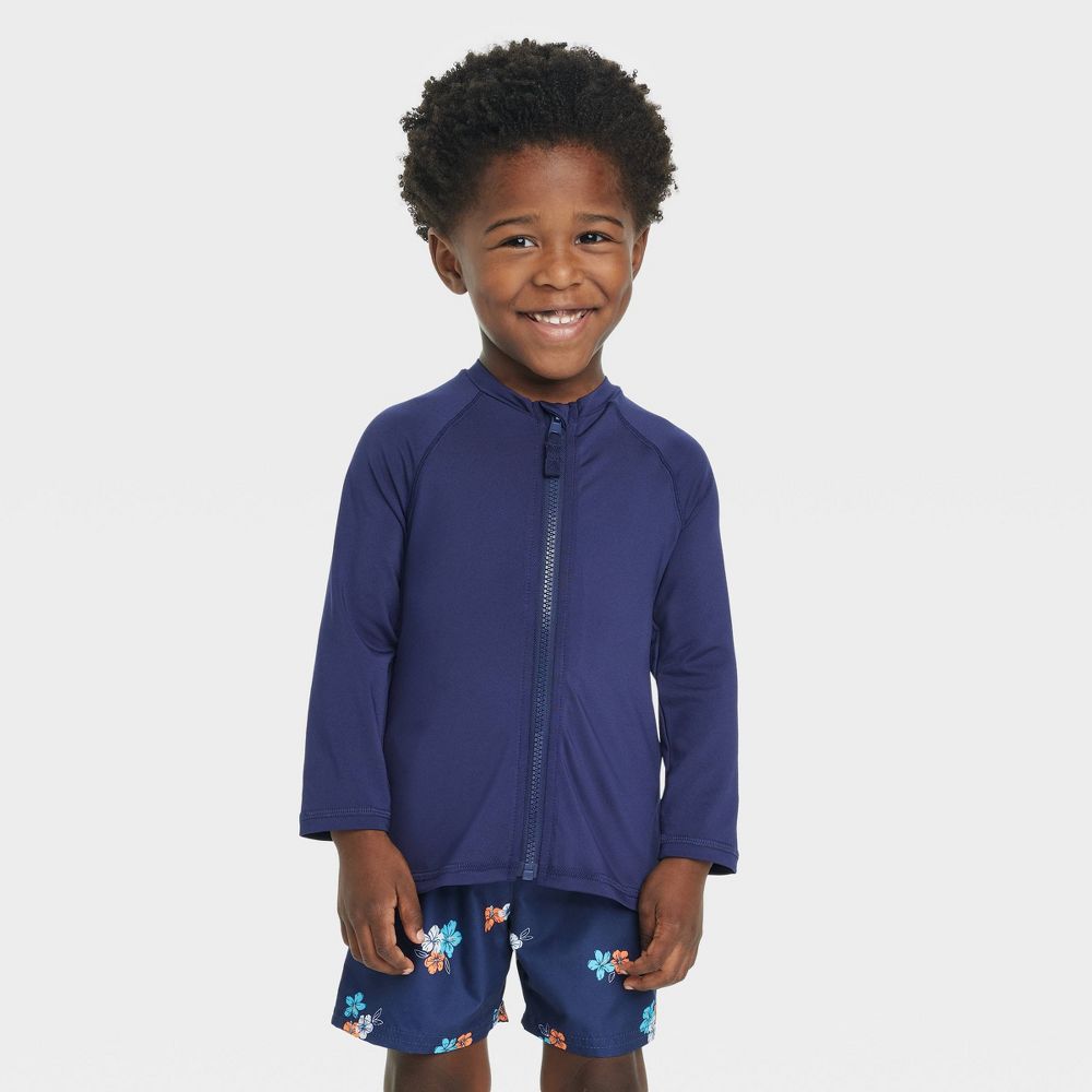 Boy in a blue rash guard top with long sleeves 