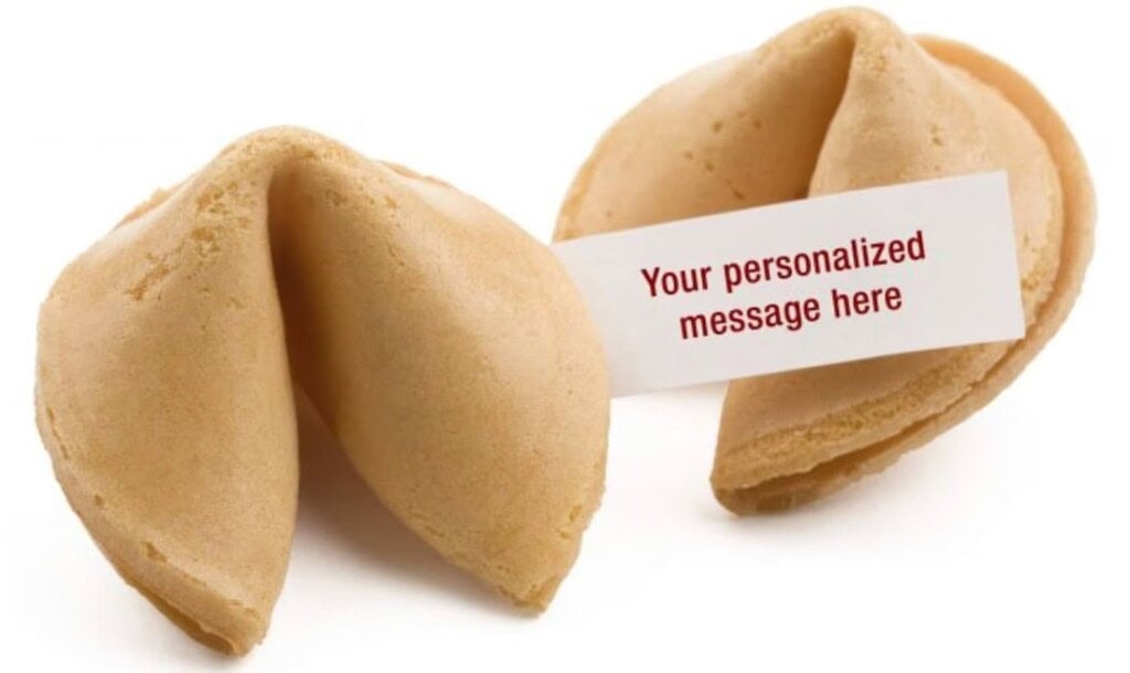 Two fortune cookies are shown, with one partially open, revealing a paper slip that reads, Tell your partner you are pregnant.