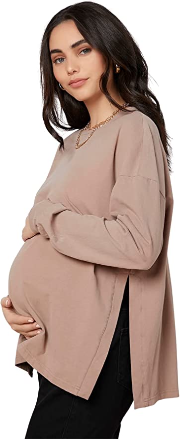 Woman in beige long-sleeve maternity shirt 