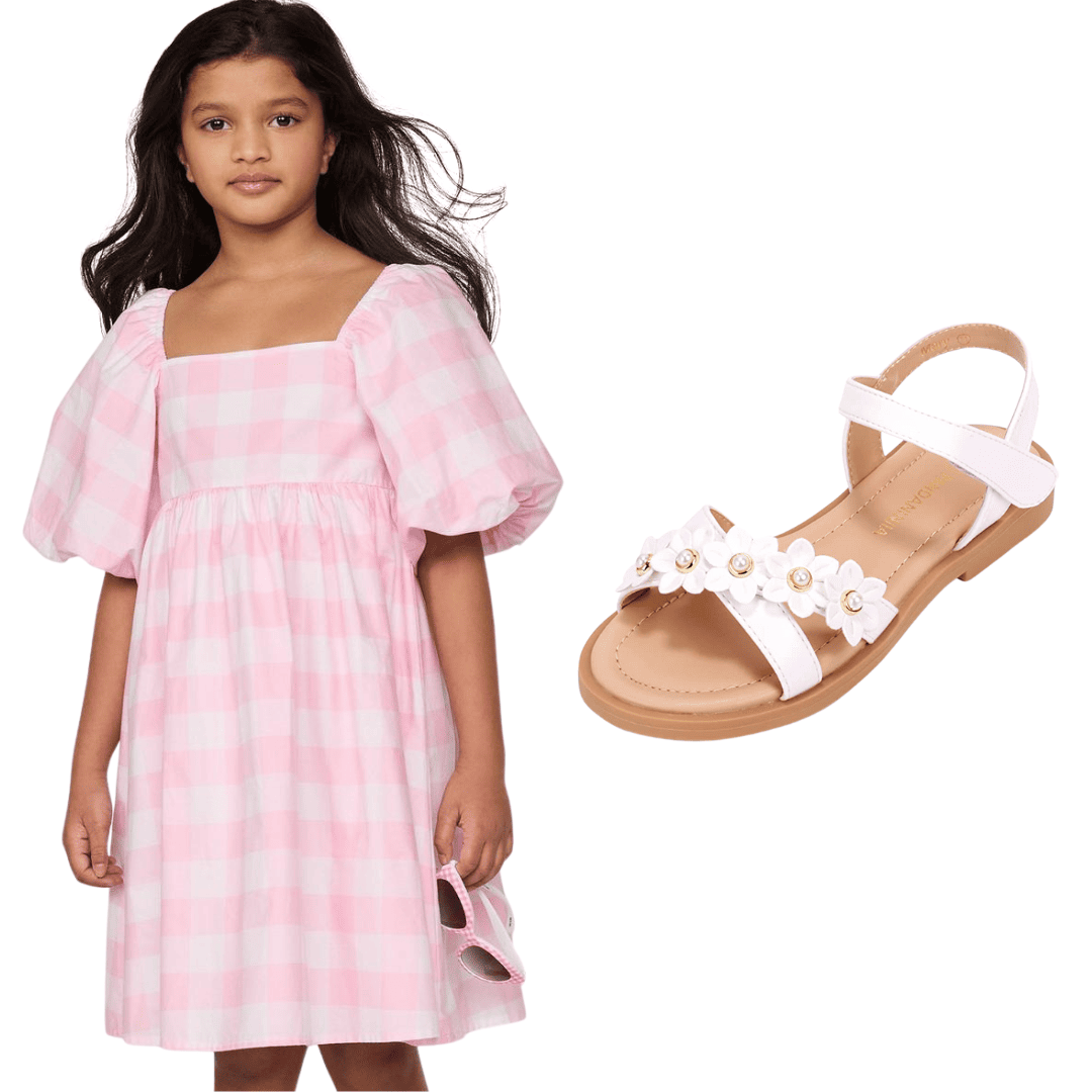 Girl in pink gingham bubble sleeve dress with white floral sandals 