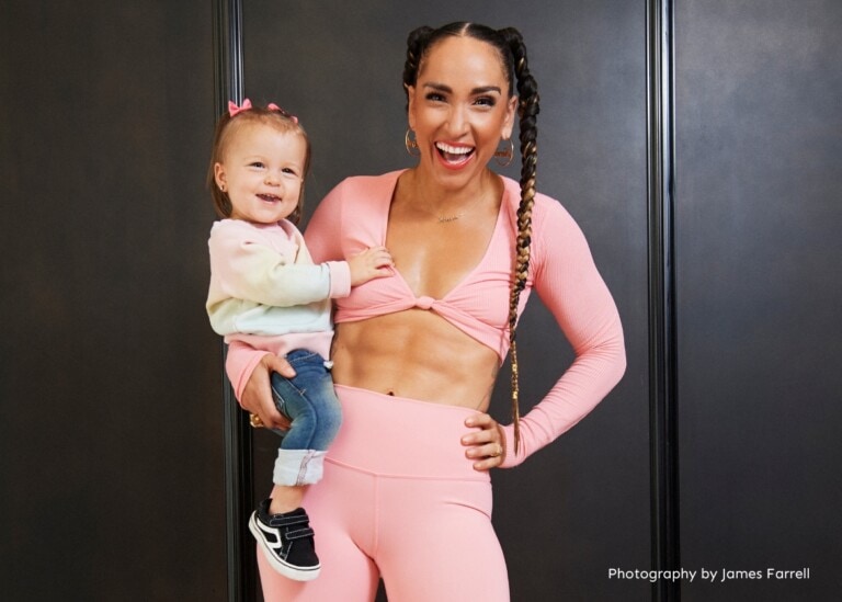 Robin Arzón holding her daughter Athena on her hip.