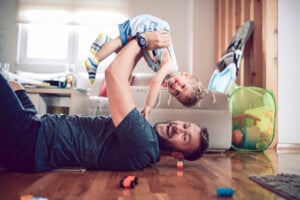 Father Playing With toddler Son In Living Room