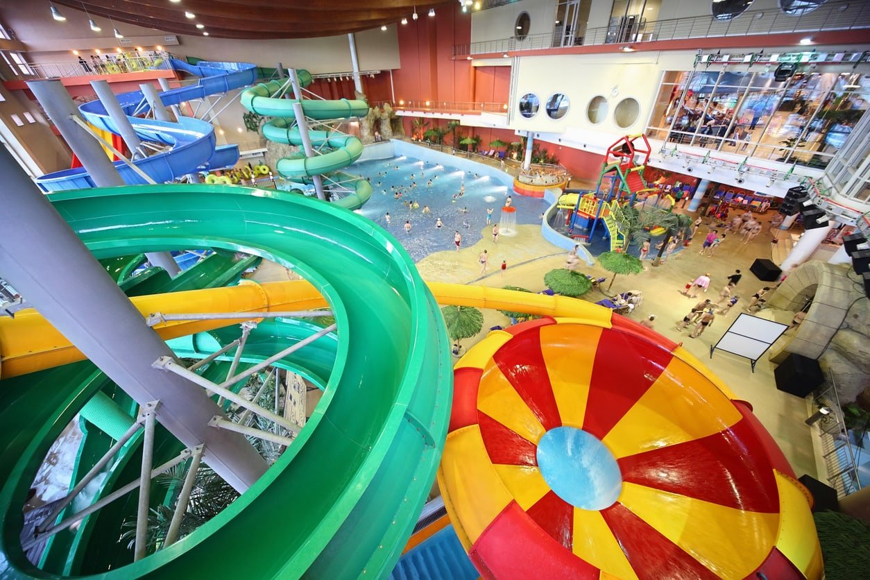 Large varicolored chutes as spiral and pool in "Kva-Kva" indoor water park.