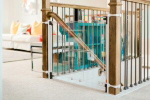 Qdos Crystal Designer Baby Safety Gate installed at the top of the stairs at someone's house.