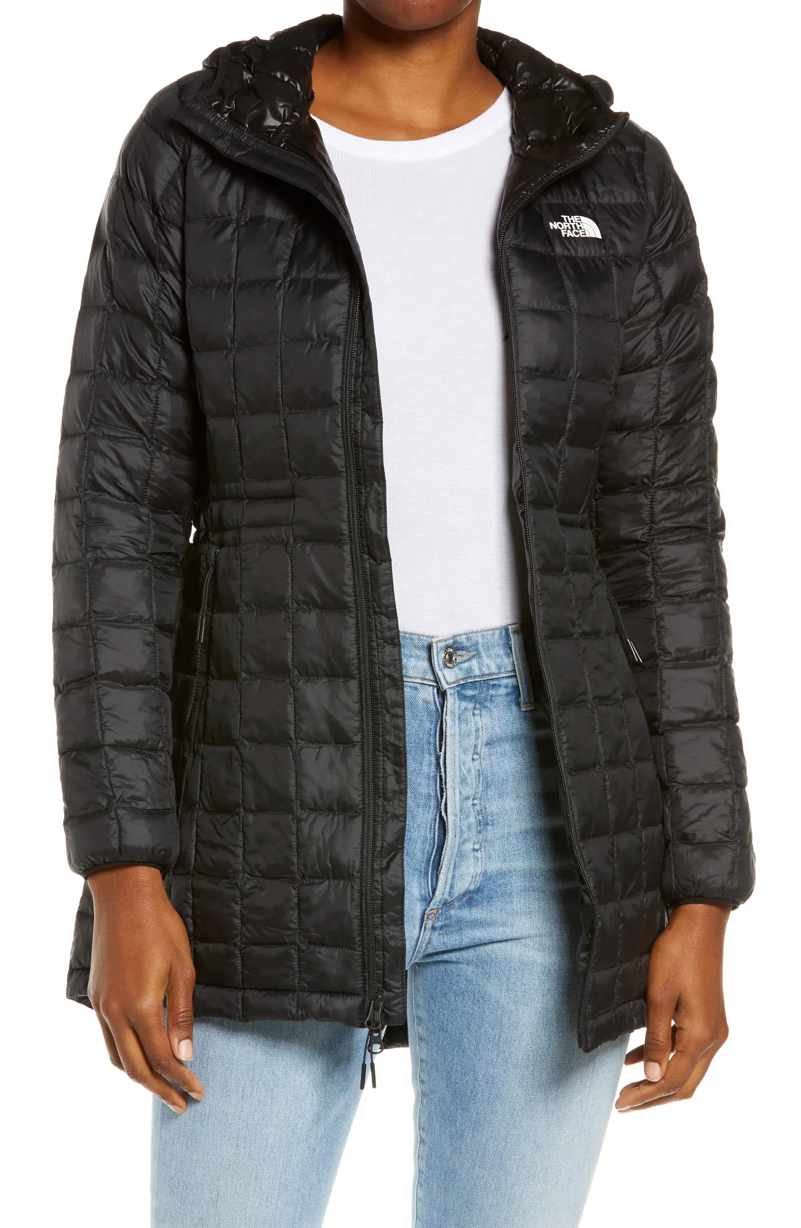 Black puffer jacket over white shirt and jeans 