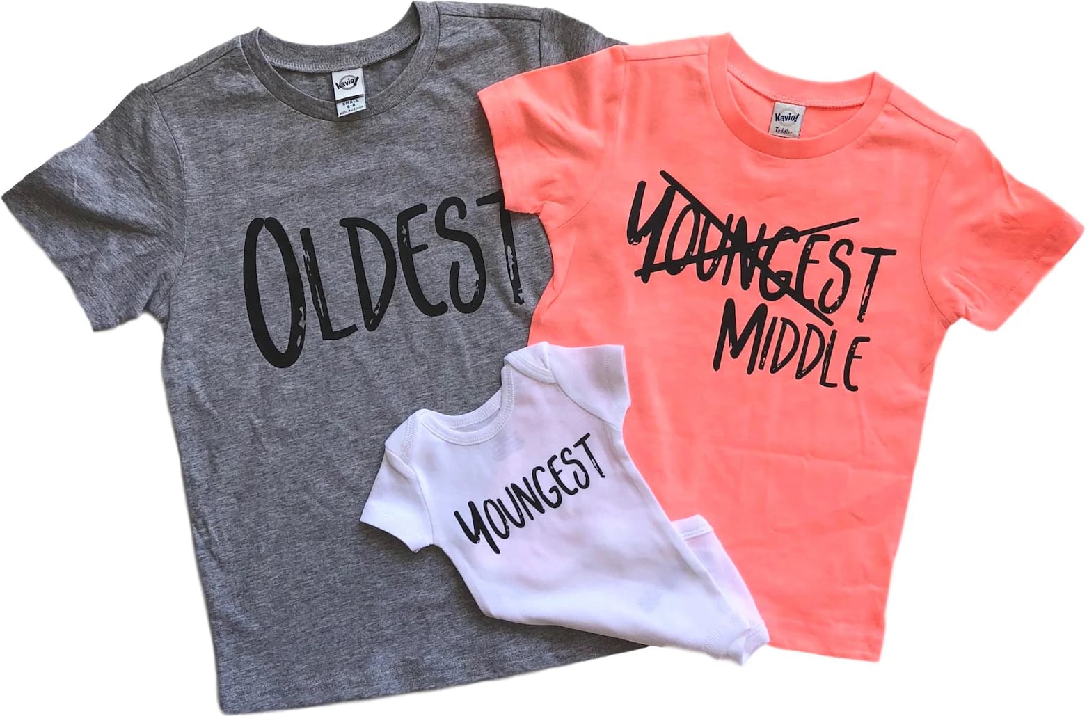 Pregnancy announcement shirts in grey, pink, and a white onesie 
