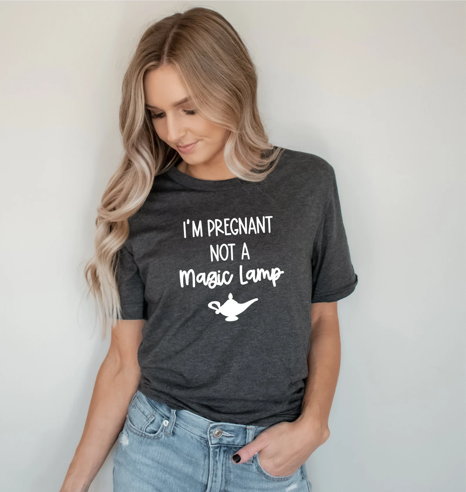 Woman in dark grey pregnancy announcement t-shirt 