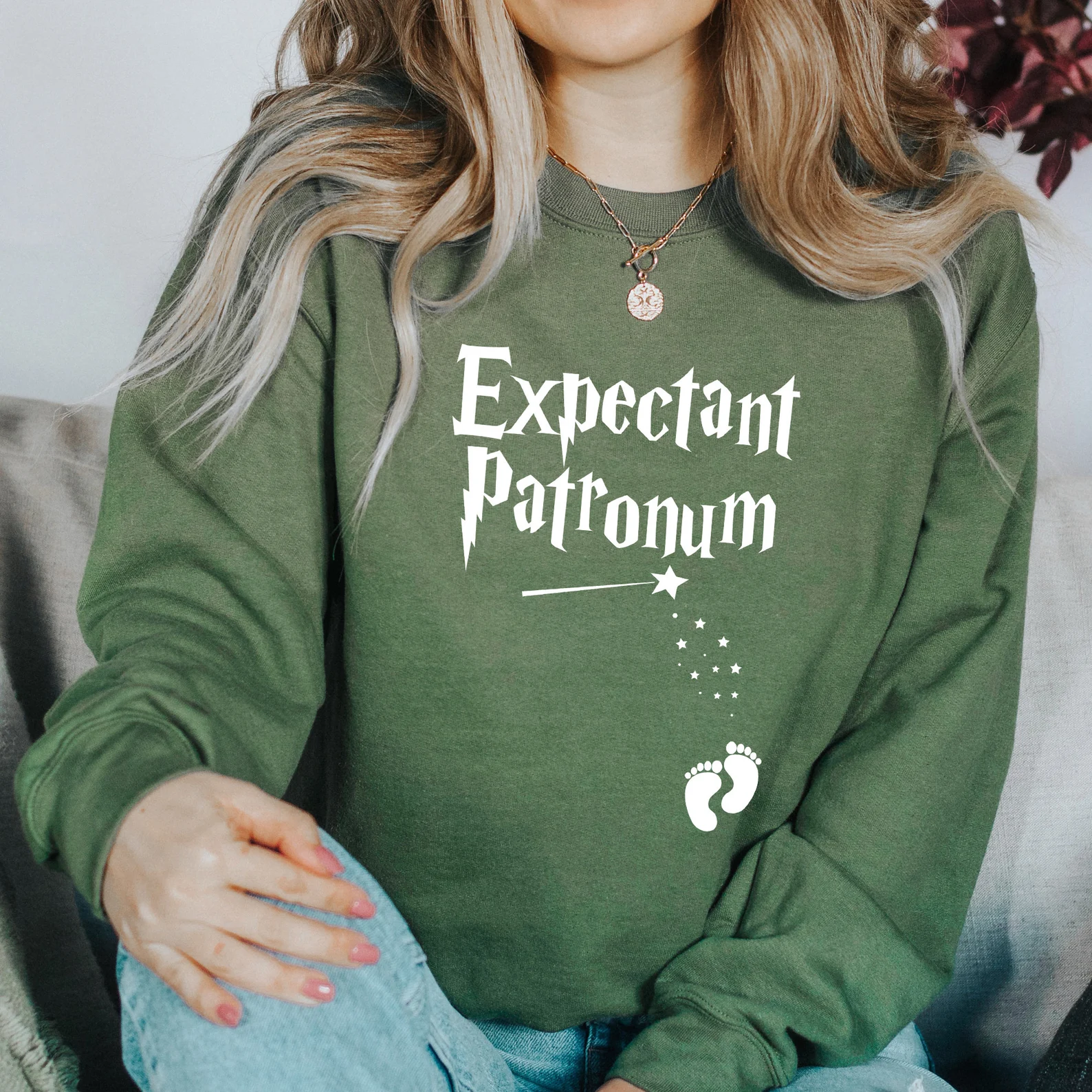 Woman in green pregnancy announcement sweatshirt 