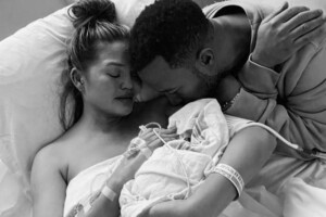 Chrissy Teigen and John Legend holding the baby they lost.