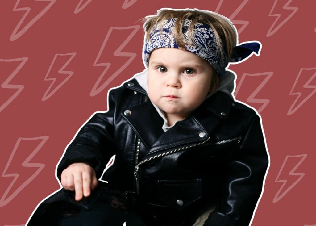 Baby boy dressed in leather jacket and bandana with lightning bolt background.