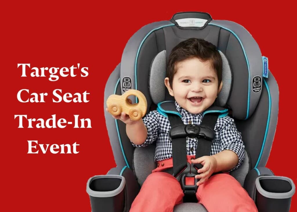 Toddler in car seat holding up a toy - Target's Car Seat Trade In event