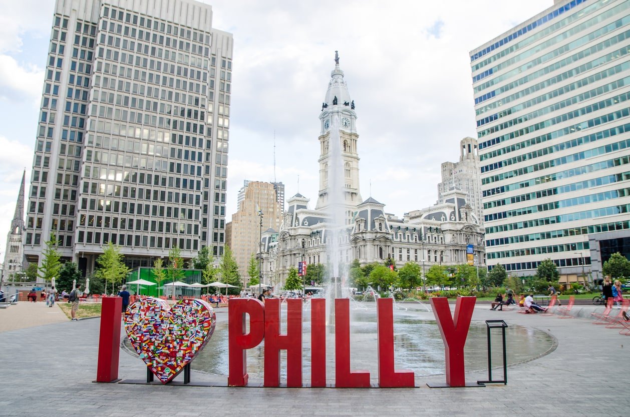 I love Philly sign at Love Park in Philadelphia during summer day. Fountain and City Hall in background.