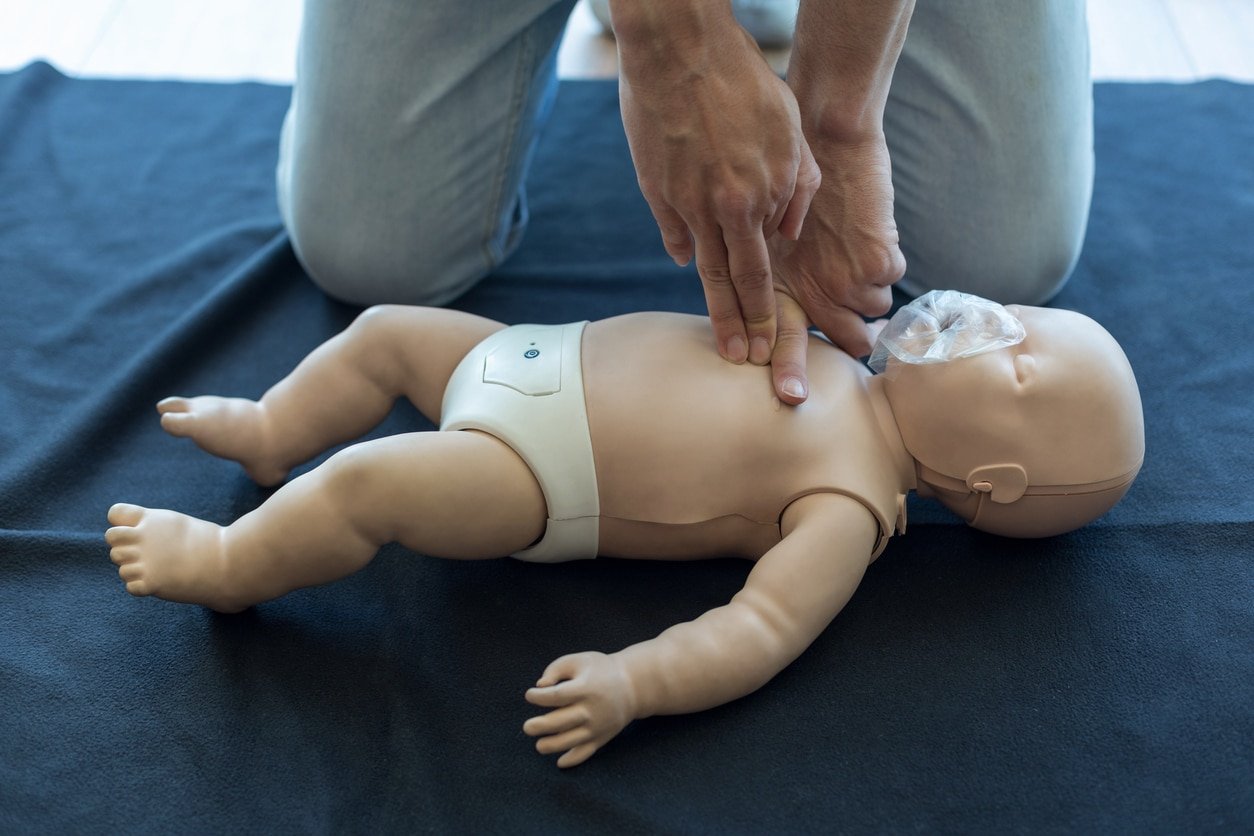 Small baby being resuscitated by paramedic doctor