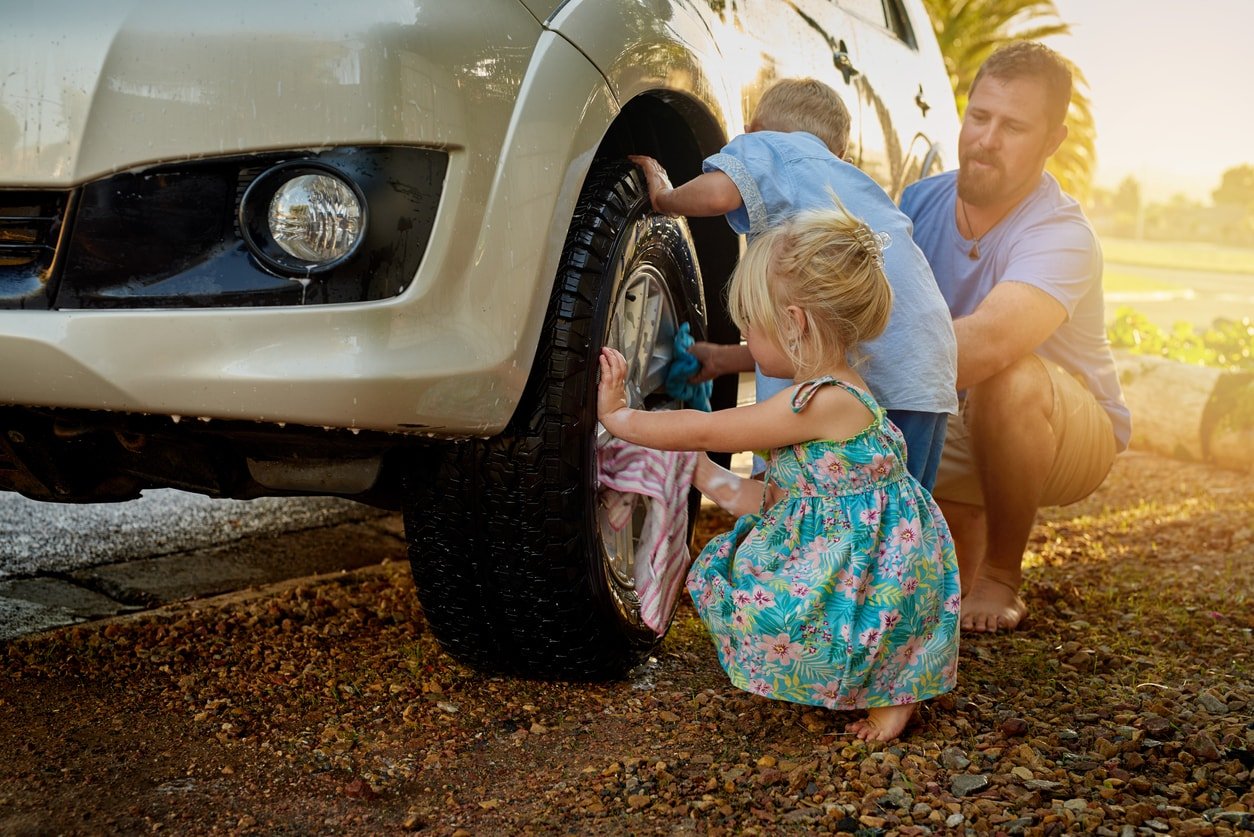 Shot of a family washing their car together