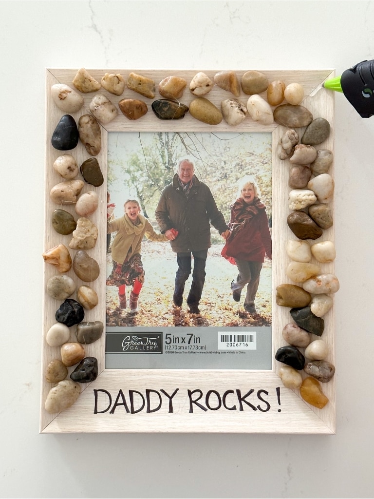 Gluing rocks on the frame - DIY kids craft for Father's Day