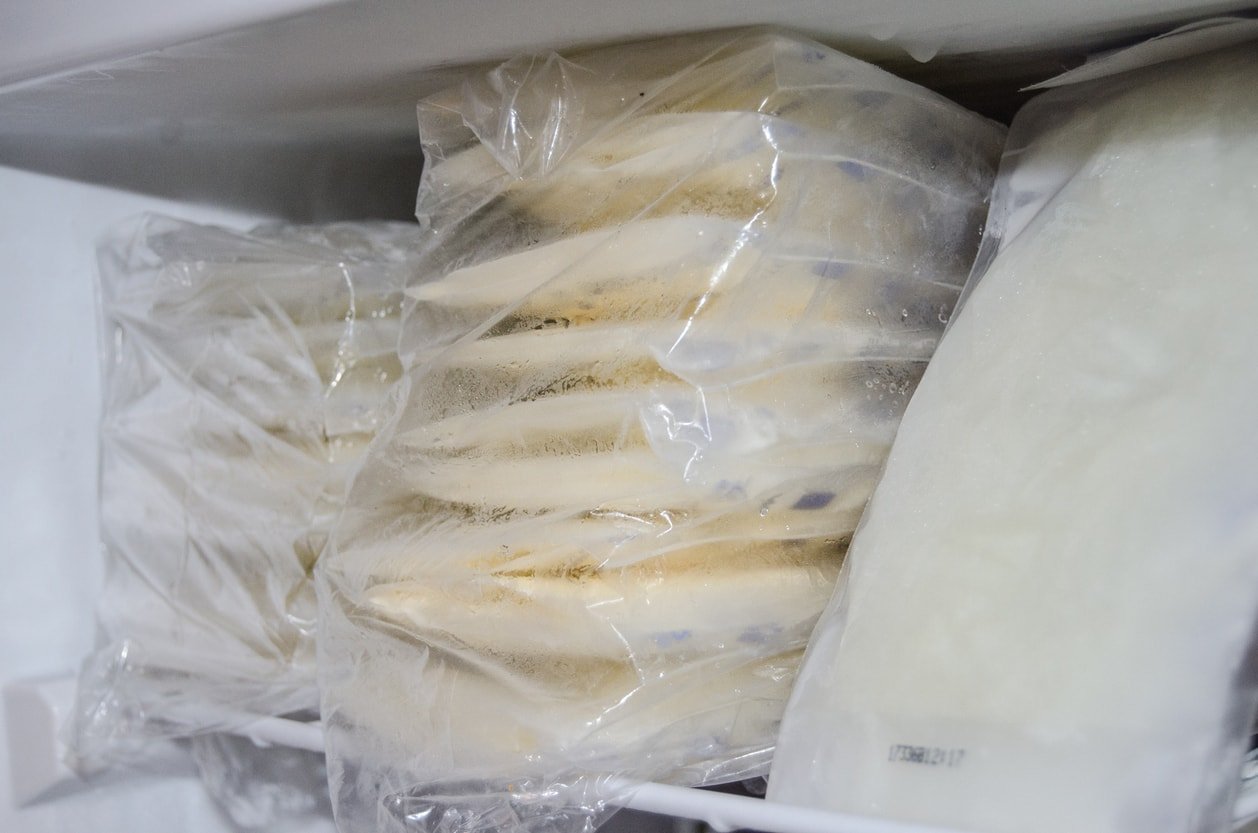 expresed breast milk packed in storage bags and frozen in the freezer, breastfeeding concept