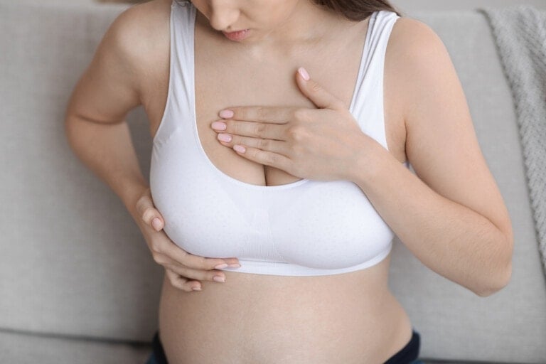 Fibrocystic Breast Disease. Closeup Shot Of Pregnant Woman Massaging Chest Area While Sitting On Couch At Home, Unrecognizable Expectant Woman Self Checking Herself Due To Painful Feelings