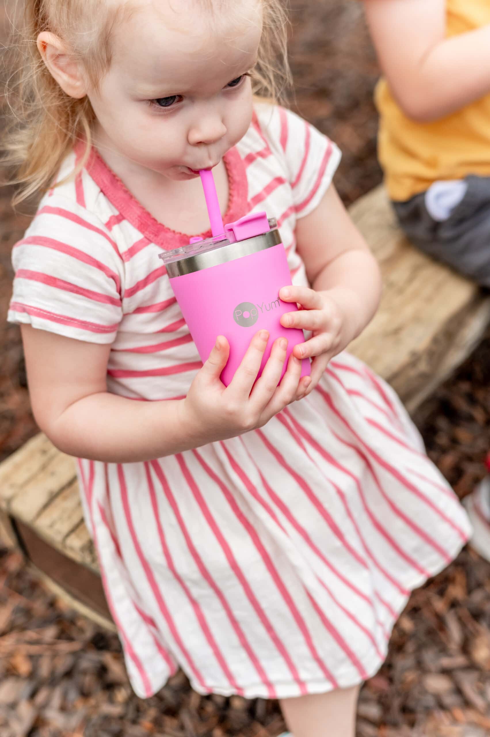 Toddler girl drinking from her pink PopYum Kids Cup